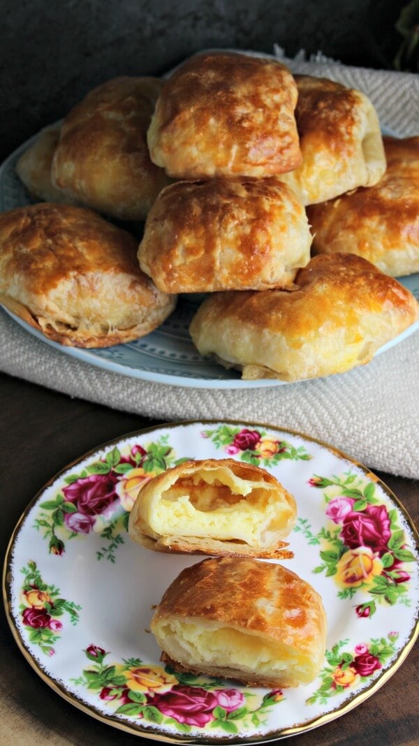 Puff pastry cheese pockets on a white plate photo.