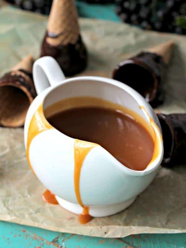 Caramel Sauce dripping of the sides of a saucer cup