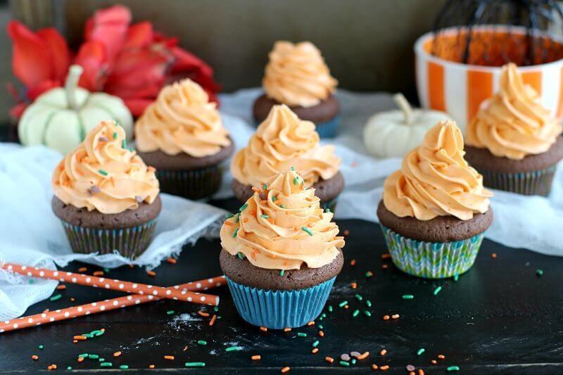 Pumpkin Spice Cupcakes topped with sprinkles on a table