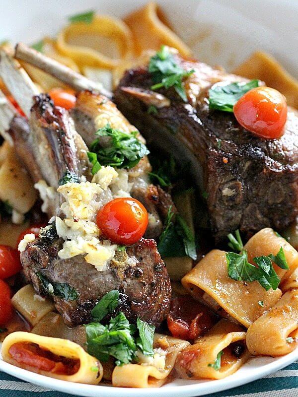 Picture of lamb chops over pasta in a plate.