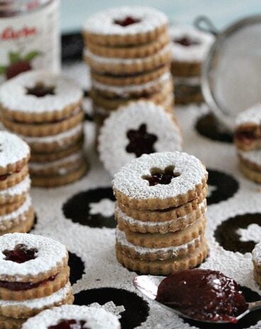 Walnut Raspberry Linzer Cookies are tender, buttery and sweet. They melt in your mouth and have a light nutty flavor and a delicious raspberry preserves middle.