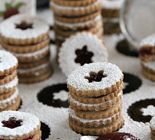 Walnut Raspberry Linzer Cookies are tender, buttery and sweet. They melt in your mouth and have a light nutty flavor and a delicious raspberry preserves middle.