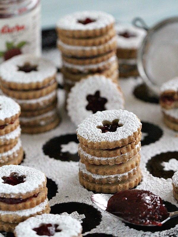 Walnut Raspberry Linzer Cookies are tender, buttery and sweet. They melt in your mouth and have a light nutty flavor and a delicious raspberry preserves middle.