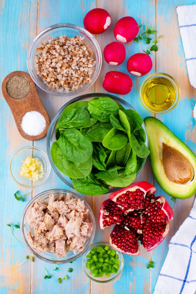 Overhead shot of avocado tuna salad ingredients in bowls on a table.