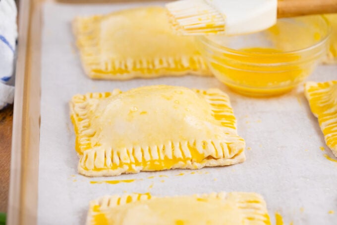 Baking puff pastry cheese pockets.