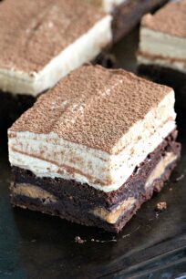 Peanut Butter Mousse Brownies are stuffed with Reese's Peanut Butter Eggs and topped with a creamy No Bake Peanut Butter Mousse. They are puffy, rich and flavorful, and very easy to make.