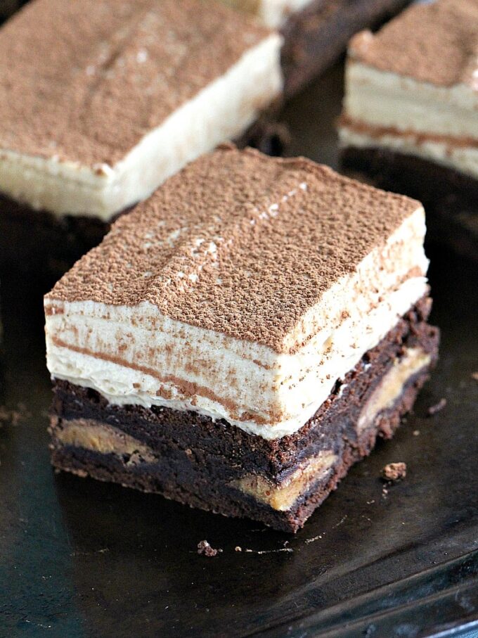 Peanut Butter Mousse Brownies are stuffed with Reese's Peanut Butter Eggs and topped with a creamy No Bake Peanut Butter Mousse. They are puffy, rich and flavorful, and very easy to make.
