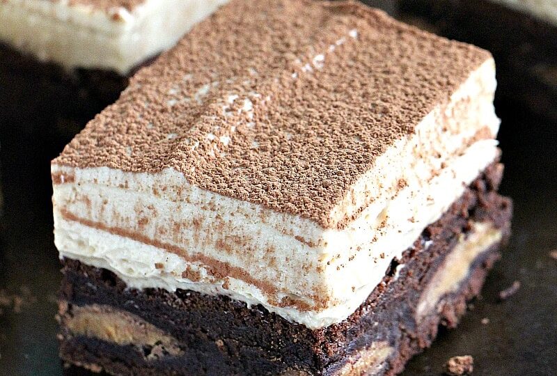 Peanut Butter Mousse Brownies are stuffed with Reese's Peanut Butter Eggs and topped with a creamy No Bake Peanut Butter Mousse. They are puffy, rich and flavorful, and very easy to make.