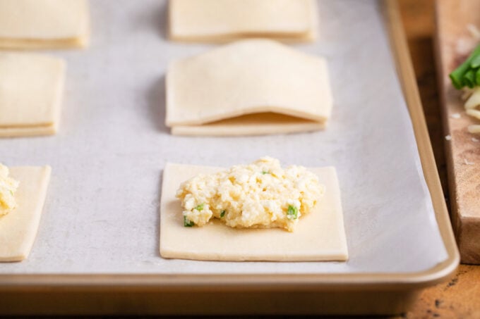 Making puff pastry cheese pockets.