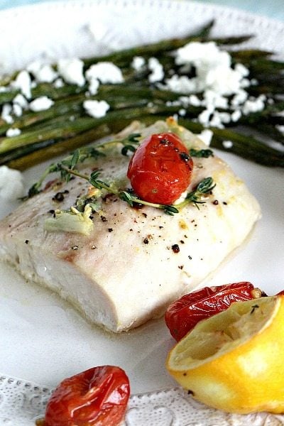 Oven Roasted Mahi Mahi in olive oil and lemon juice, served with roasted grape tomatoes and asparagus, made in just 30 minutes.