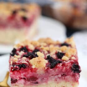 Cherry Cream Cheese Coffee Cake is made with a cake layer topped with a cheesecake filling, juicy cherries and a buttery crumb topping. #coffeecake #brunch #cherries #sweetandsavorymeals #desserts