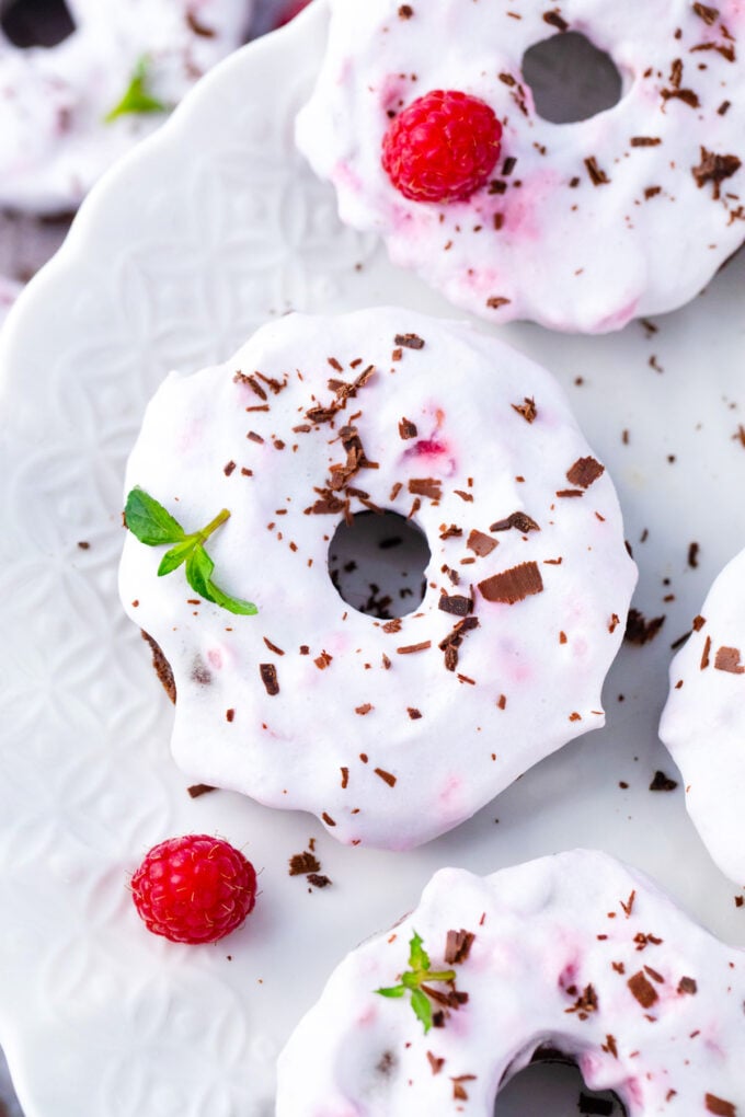 Coconut frosting topped flourless chocolate cake baked donuts.