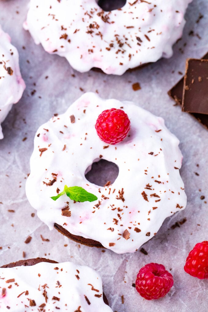 Coconut frosting topped flourless chocolate cake baked donuts.