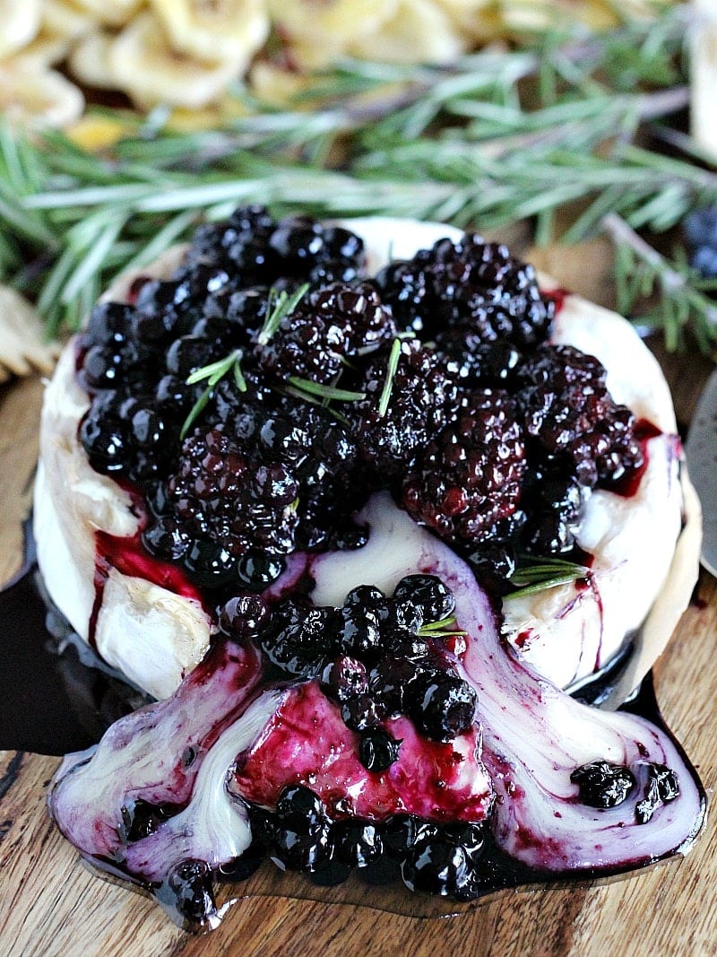 Rosemary Berry Baked Brie is a creamy and flavorful showstopper appetizer. Topped with coconut oil roasted berries and fresh rosemary for maximum flavor.