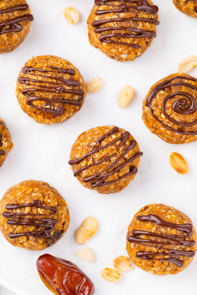 Overhead shot of peanut butter truffles drizzled with chocolate.