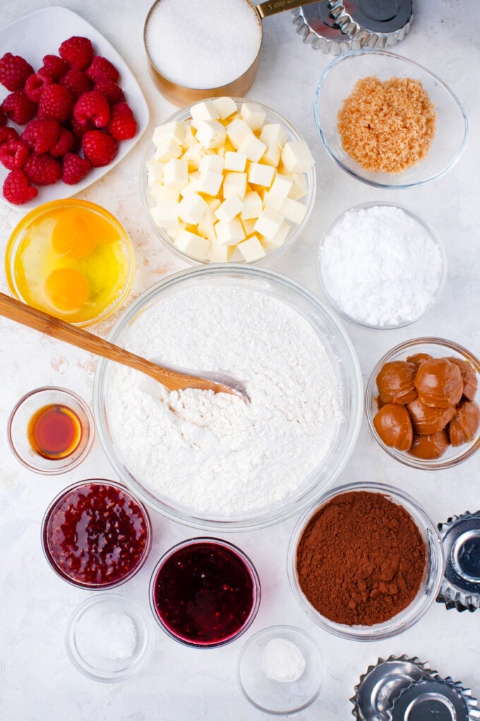 Overhead shot of chocolate Linzer cookies recipe ingredients in bowls.