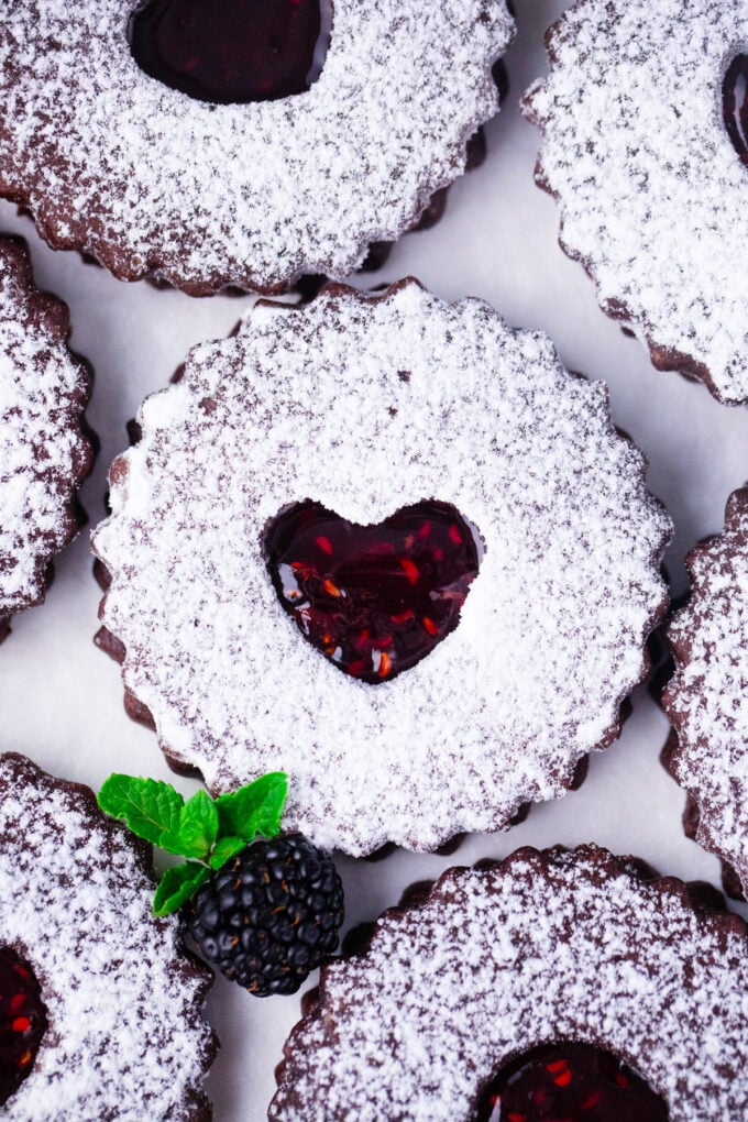 Overhead shot of raspberry jam chocolate Linzer cookies.