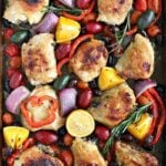 One Sheet Pan Mediterranean Chicken with olives, capers, red onion, red pepper and grape tomatoes in a fresh lemon orange honey sauce. A hearty, easy meal!