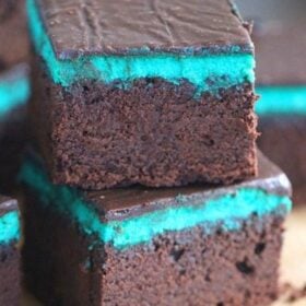 Rich and chocolaty Mint Brownies are topped with a creamy Mint Cheesecake layer and finished with a sweet layer of Chocolate Ganache.
