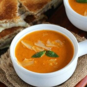Instant Pot Tomato Soup made with garlic roasted tomatoes for extra flavor. Super creamy and with a spicy kick, made in minutes in the Instant Pot.