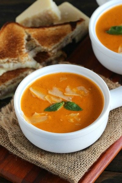 Instant Pot Tomato Soup made with garlic roasted tomatoes for extra flavor. Super creamy and with a spicy kick, made in minutes in the Instant Pot.