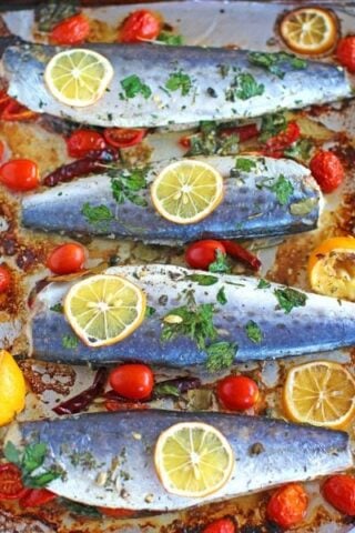 Healthy Oven Roasted Spanish Mackerel marinated with grape tomatoes, capers, dried chili peppers and lemon is one very tasty and easy meal to make.