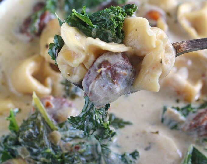 Slow Cooker Tortellini Soup that can be made in the Crockpot or Instant Pot! Creamy, loaded with chicken sausage, veggies, kale and three cheese tortellini.