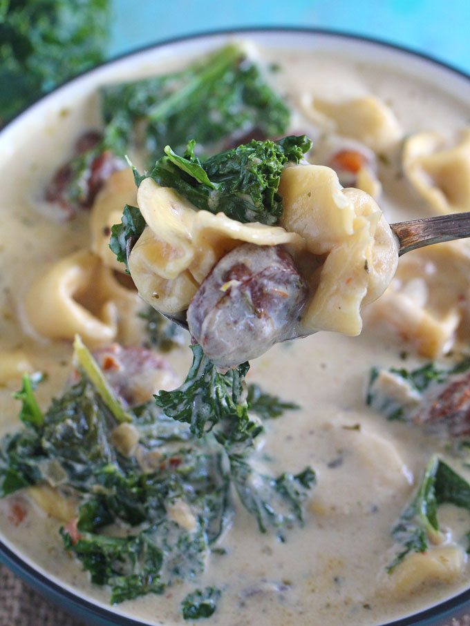 Slow Cooker Tortellini Soup that can be made in the Crockpot or Instant Pot! Creamy, loaded with chicken sausage, veggies, kale and three cheese tortellini.