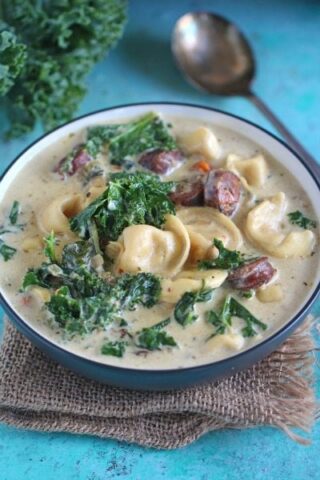 Slow Cooker Tortellini Soup that can be made in the Crockpot or Instant Pot! Creamy, loaded with chicken sausage, veggies, kale and three cheese tortellini.