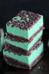 Mint Chocolate Chip Fudge over incredibly fudgy and chocolaty brownies is the best combo ever. Any mint chocolate chip fan will love this easy dessert.