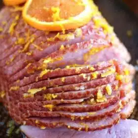 Slow Cooker Brown Sugar Ham with Orange Glaze is an amazingly flavorful and refreshing way to easily cook ham to juicy perfection in your slow cooker.