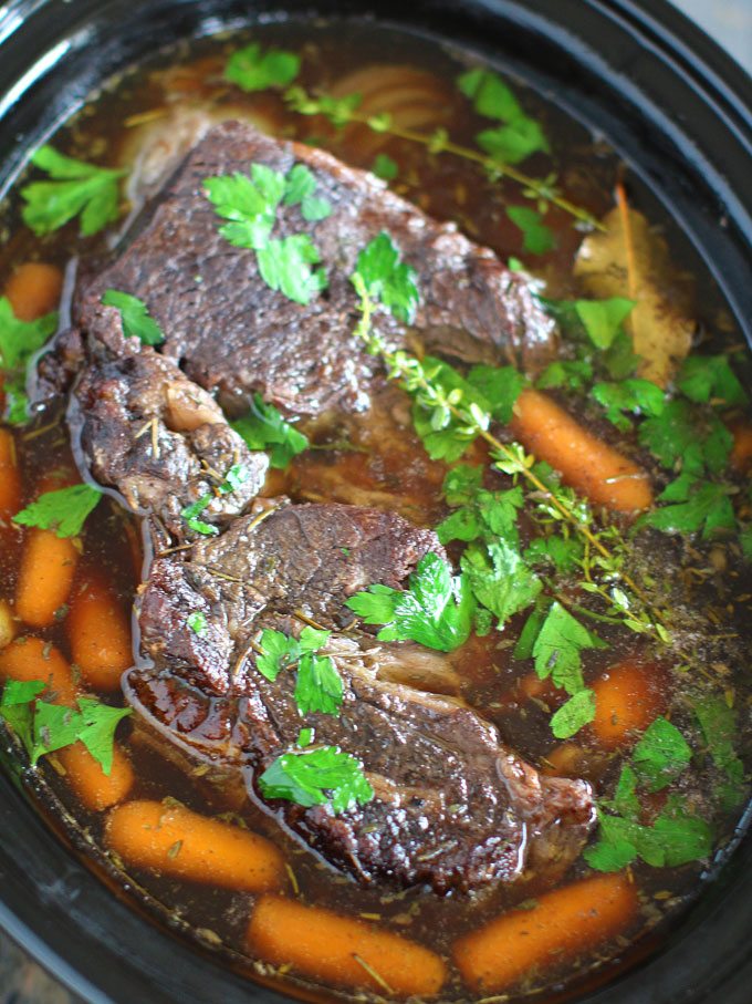 Image of slow cooker pot roast with carrots. 