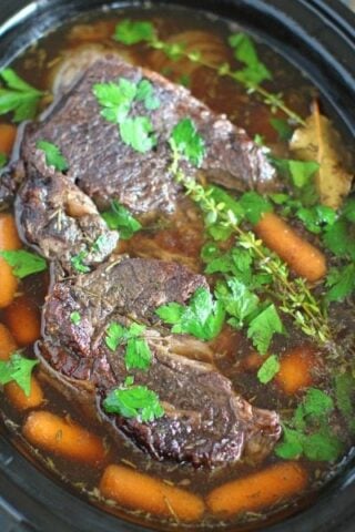 Slow Cooker Pot Roast made with red wine is such an easy and delicious meal, hearty and packed with meat and veggies it is perfect for any occasion.