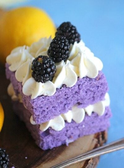 Vanilla Purple Cake with Lemon Buttercream is cut into mini individual cakes decorated with fresh blackberries, for a beautiful and tasty dessert.
