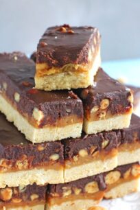 Homemade Snickers Bars are very easy to make and melt in your mouth with deliciousness. Buttery shortbread, caramel with crunchy peanuts and chocolate!