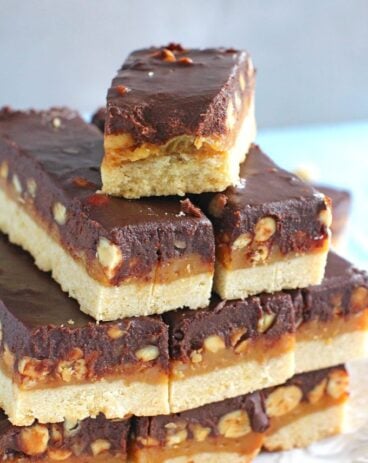 Homemade Snickers Bars are very easy to make and melt in your mouth with deliciousness. Buttery shortbread, caramel with crunchy peanuts and chocolate!