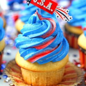 Red White and Blue Cupcakes are the perfect patriotic treat. Tasty vanilla cupcakes are topped with sweet red, white and blue buttercream swirl.