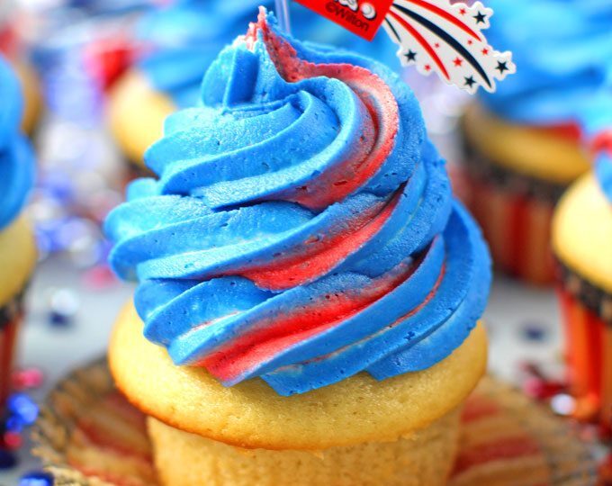 Red White and Blue Cupcakes are the perfect patriotic treat. Tasty vanilla cupcakes are topped with sweet red, white and blue buttercream swirl.