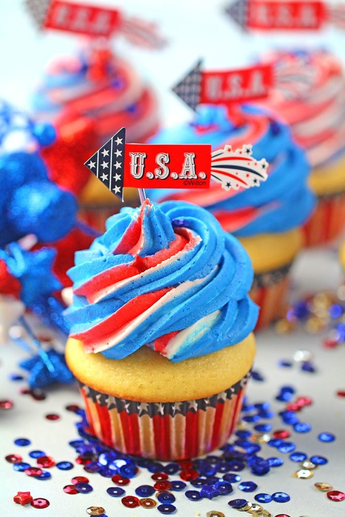 Red White and Blue Cupcakes are the perfect patriotic treat. Fluffy and soft vanilla cupcakes are topped with sweet red, white and blue buttercream swirl.