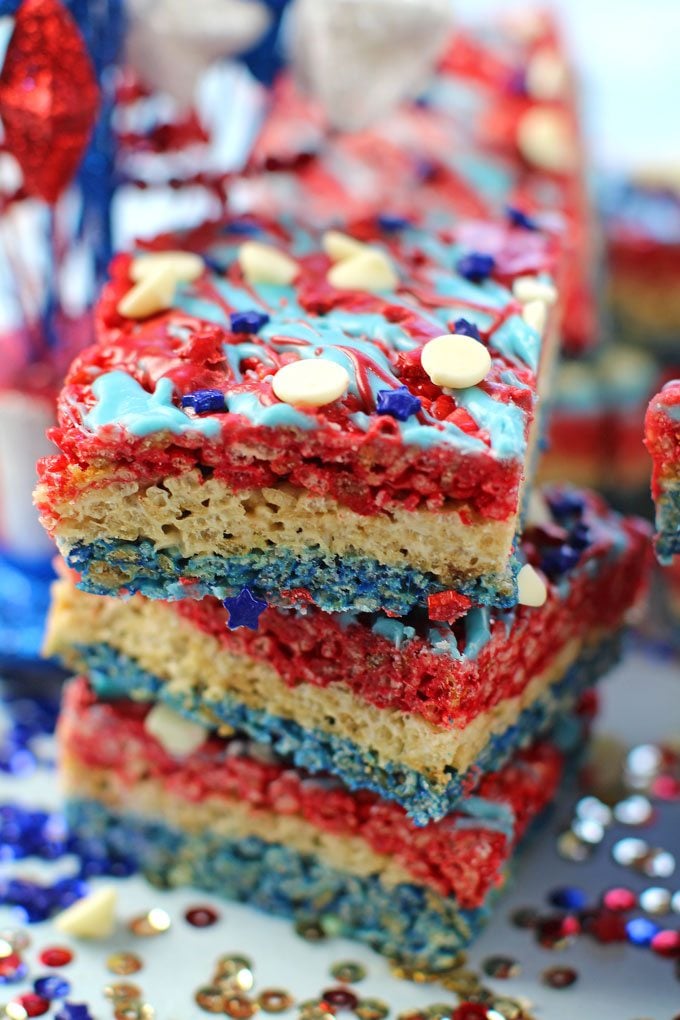 Red White and Blue Rice Krispy Treats are fluffy, sweet and very easy to make. Colored in red, white and blue to look patriotic and fun.