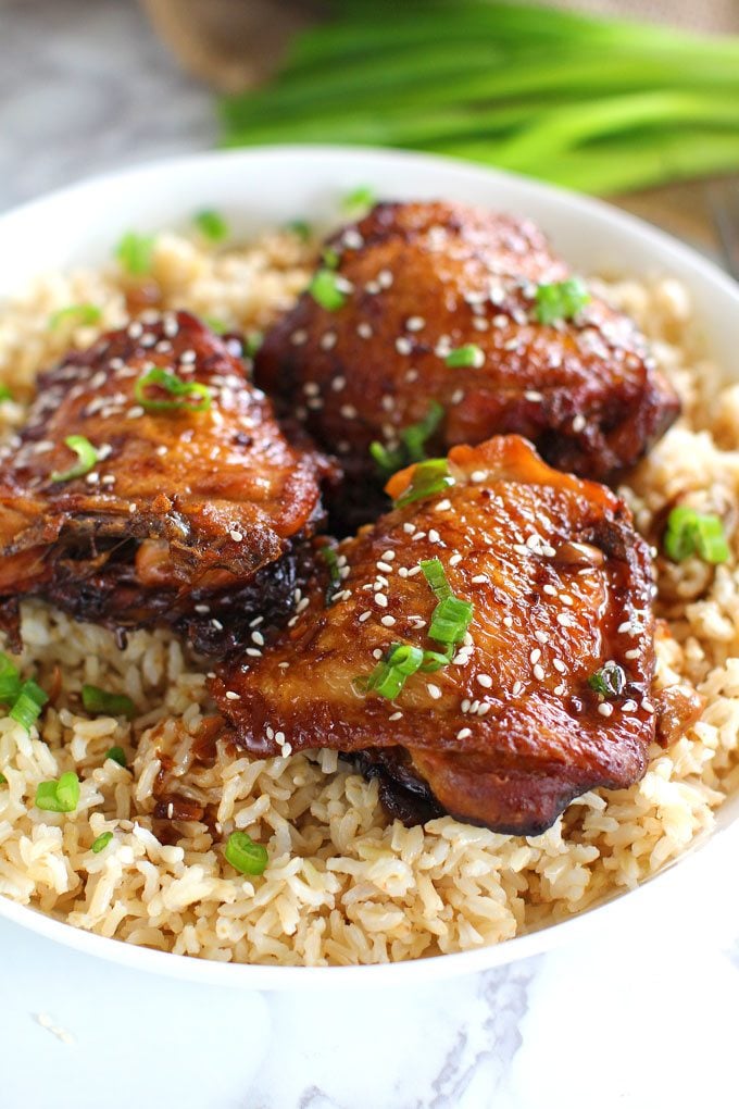 Crispy Slow Cooker Garlic Sesame Chicken thighs over rice