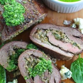 Stuffed Flank Steak with Spinach and Blue Cheese is packed with garlic, caramelized onions and walnuts.