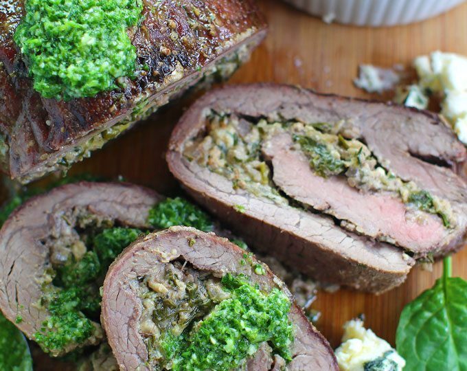 Stuffed Flank Steak with Spinach and Blue Cheese is packed with garlic, caramelized onions and walnuts.