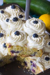 Blueberry Zucchini Poke Cake is so tender, moist and delicious. Made with zucchini, olive oil, lots of fresh lemon zest and juicy blueberries.