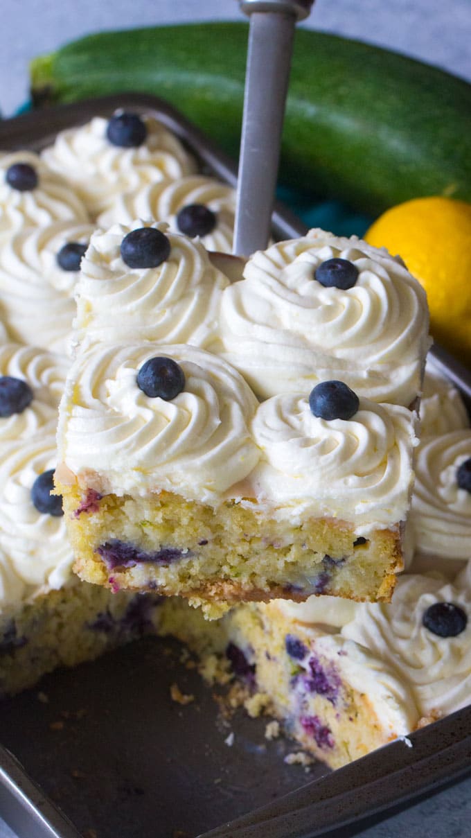 Blueberry Zucchini Poke Cake is so tender, moist and delicious. Made with zucchini, olive oil, lots of fresh lemon zest and juicy blueberries.