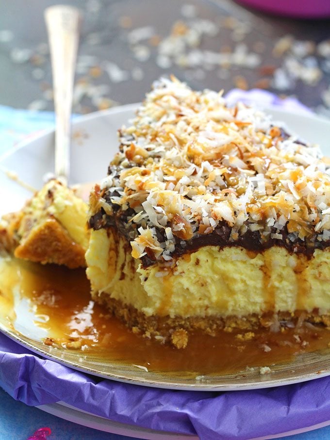 No Bake Samoa Cheesecake is so creamy and indulgent. Topped with chocolate ganache, lots of toasted coconut and finished with caramel sauce.