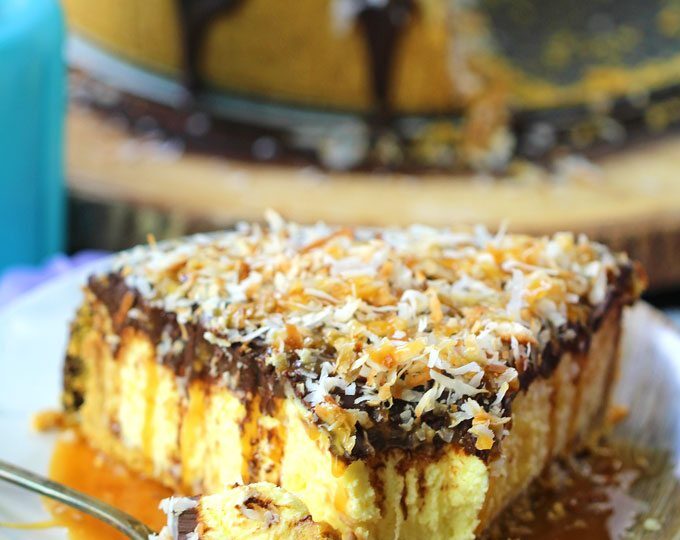 No Bake Coconut Cheesecake is so creamy and indulgent. Topped with chocolate ganache, lots of toasted coconut and finished with caramel sauce.