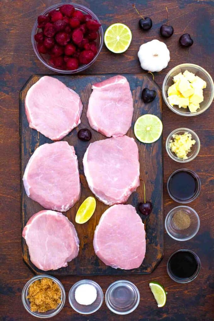 overhead shot of boneless pork chops on a cutting board and ingredients in bowls