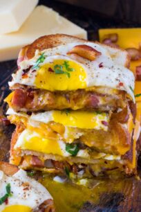 Monte Cristo Grilled Cheese sandwiches are deliciously stuffed with fried ham, bacon, cheese and topped with a perfect runny egg.