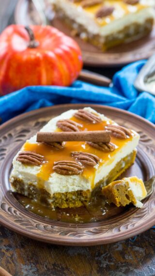 White Chocolate Pumpkin Poke Cake is deliciously infused with a sweet white chocolate sauce, topped with cream cheese frosting, caramel and crunchy pecans.